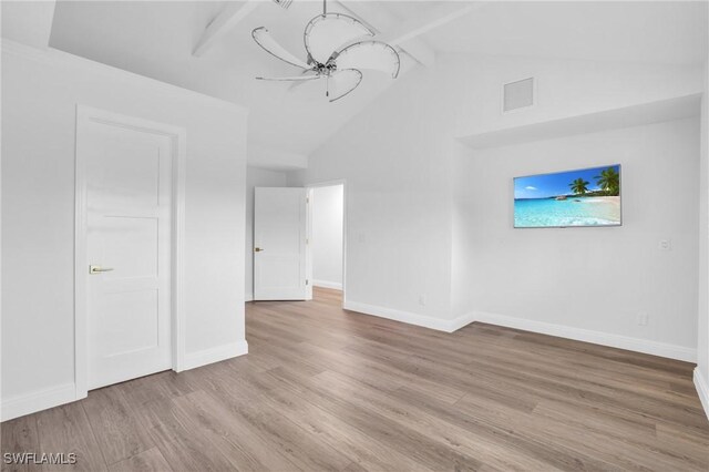 unfurnished living room featuring light hardwood / wood-style flooring, high vaulted ceiling, and beamed ceiling