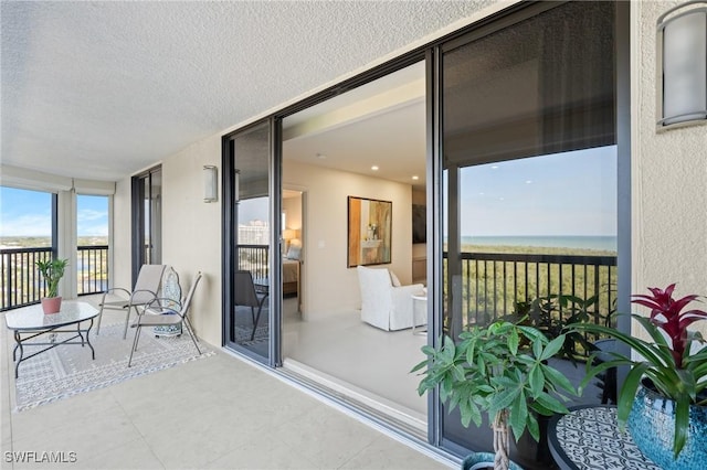 sunroom / solarium with a water view