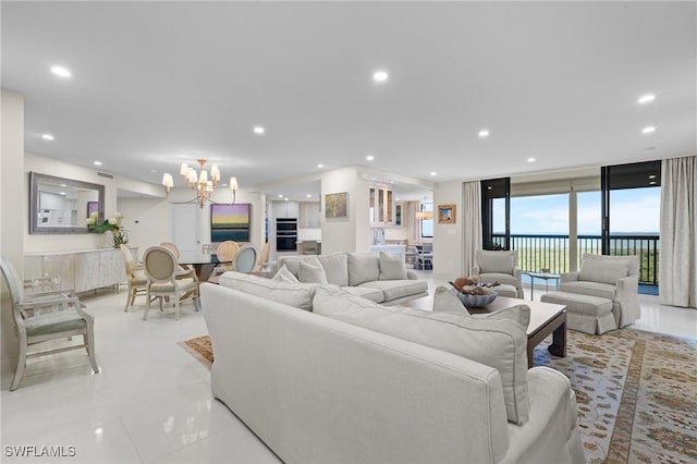 tiled living room featuring floor to ceiling windows and an inviting chandelier