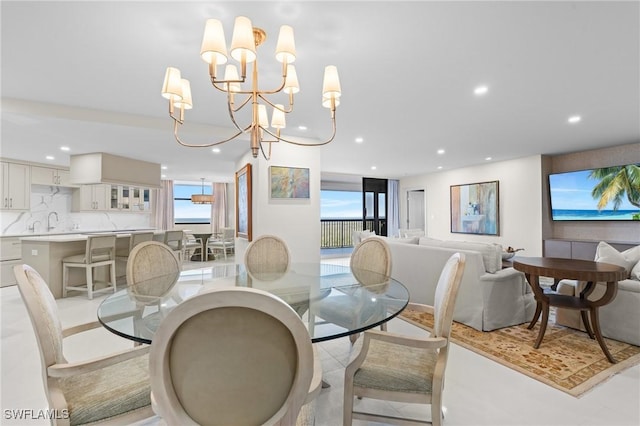 dining room with sink and a chandelier