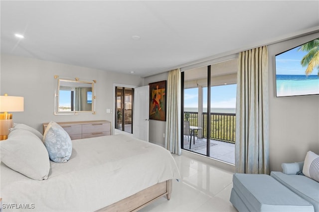 bedroom with access to exterior and a water view