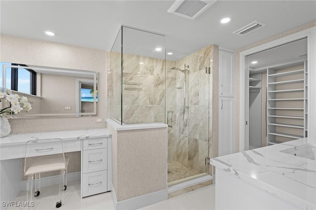 bathroom with tile patterned floors, vanity, and an enclosed shower