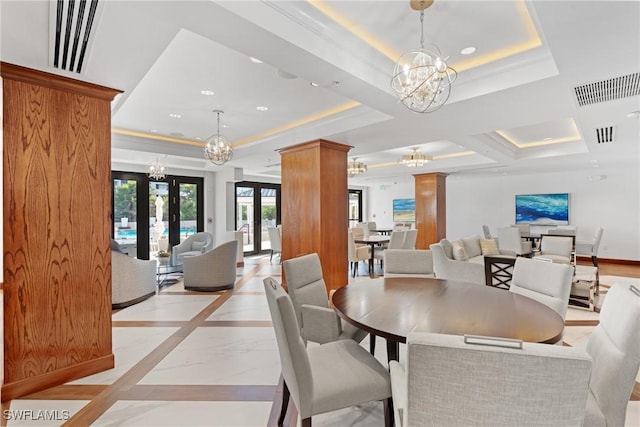 dining area with french doors and a raised ceiling