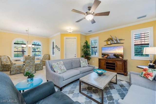 living room featuring ceiling fan with notable chandelier and crown molding