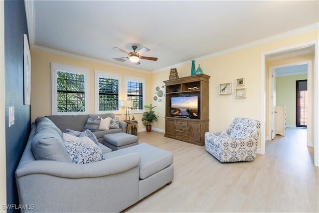 living room with ornamental molding, ceiling fan, and light hardwood / wood-style flooring