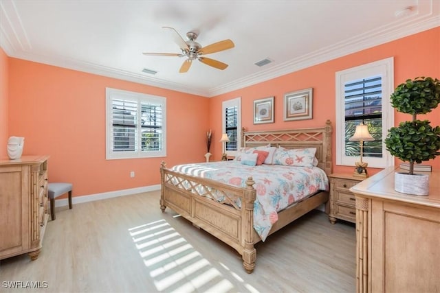 bedroom with multiple windows, ceiling fan, crown molding, and light hardwood / wood-style flooring