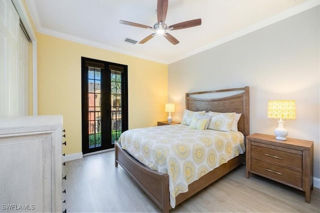 bedroom featuring ornamental molding, light wood-type flooring, ceiling fan, and access to exterior