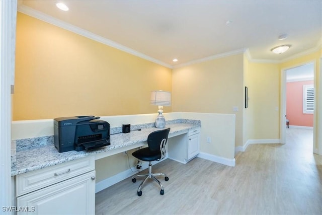 office with built in desk, light wood-type flooring, and crown molding