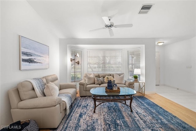 living room featuring hardwood / wood-style floors and ceiling fan