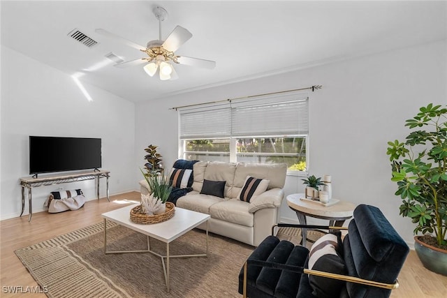 living room featuring hardwood / wood-style floors and ceiling fan