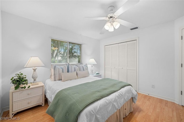 bedroom with light hardwood / wood-style flooring, a closet, and ceiling fan