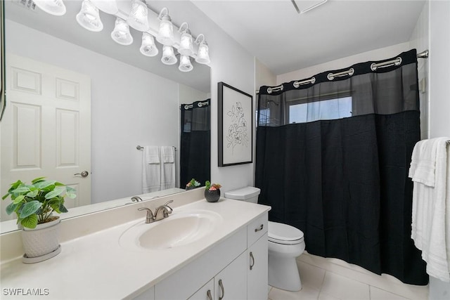 bathroom featuring tile patterned flooring, vanity, and toilet