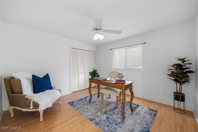 office with wood-type flooring and ceiling fan