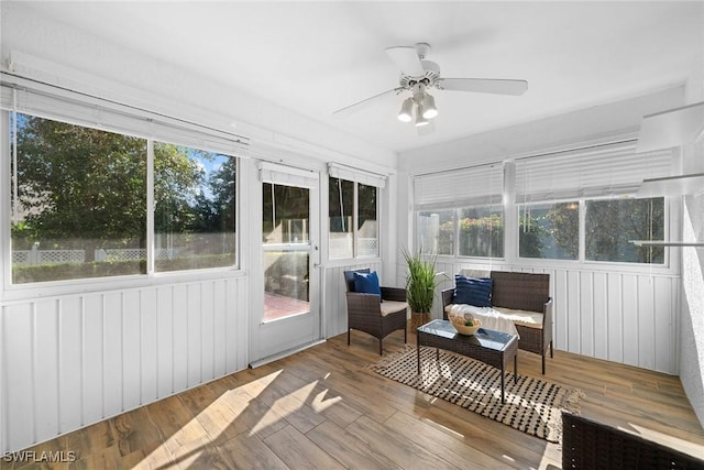 sunroom / solarium featuring ceiling fan