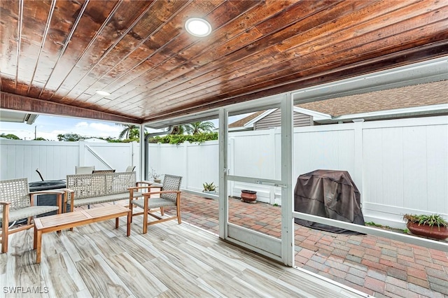 sunroom / solarium featuring wood ceiling