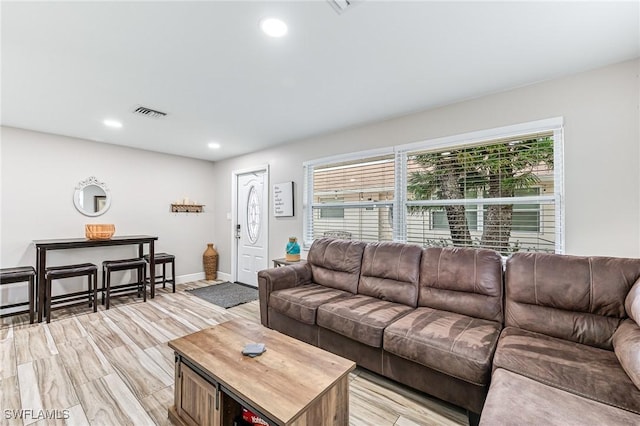 living room featuring plenty of natural light and light hardwood / wood-style flooring