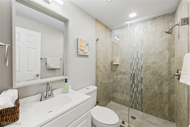 bathroom featuring walk in shower, vanity, and toilet