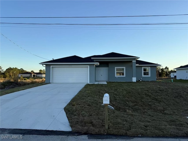 view of front facade featuring a garage and a front lawn