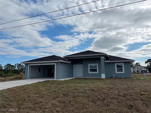 view of front of home featuring a garage and a front lawn