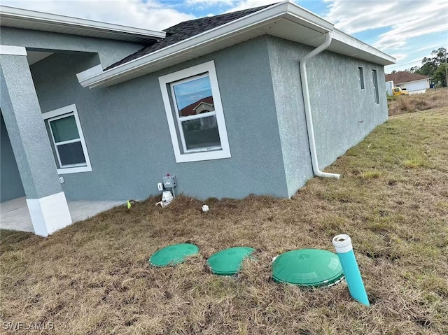 view of home's exterior with a lawn