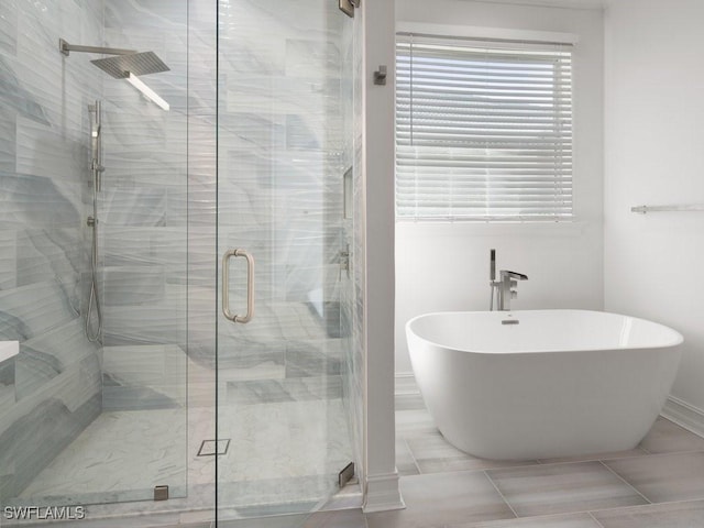 bathroom featuring shower with separate bathtub