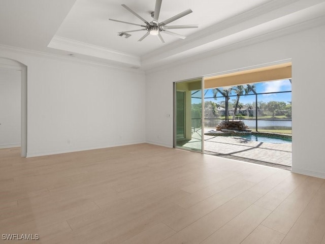 unfurnished room featuring crown molding, light hardwood / wood-style floors, a raised ceiling, and ceiling fan