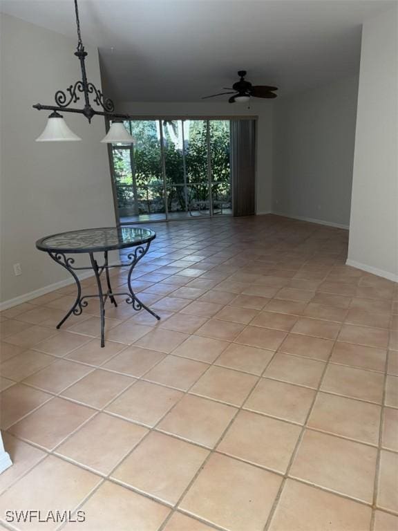 tiled dining space with ceiling fan