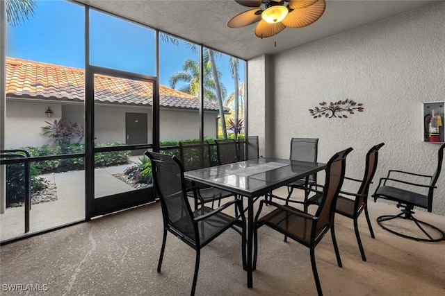 sunroom featuring ceiling fan