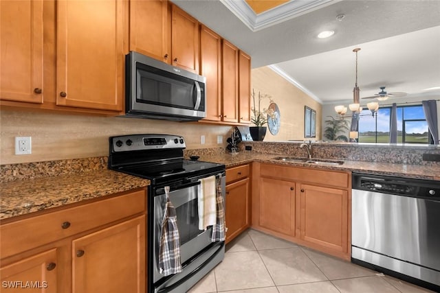 kitchen featuring ceiling fan, dark stone countertops, sink, appliances with stainless steel finishes, and ornamental molding