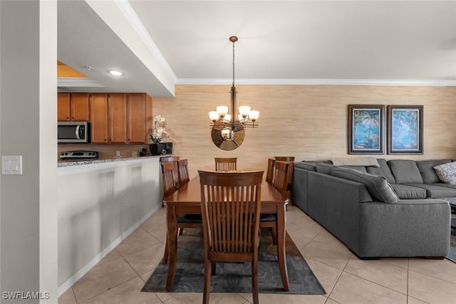 tiled dining area featuring a chandelier and crown molding