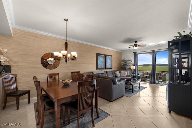 tiled dining space featuring ceiling fan with notable chandelier and crown molding