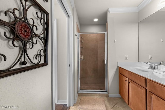 bathroom featuring a shower with shower door, tile patterned floors, vanity, and ornamental molding