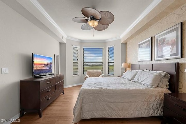 bedroom featuring ceiling fan, ornamental molding, and light hardwood / wood-style flooring