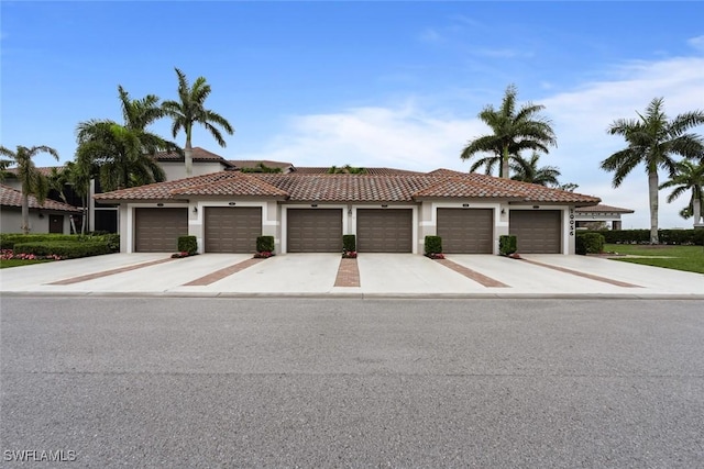 mediterranean / spanish-style house with a garage