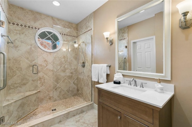 bathroom featuring vanity and a shower with shower door