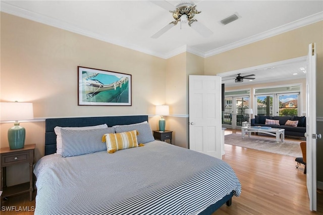 bedroom featuring french doors, light wood-type flooring, ceiling fan, and ornamental molding