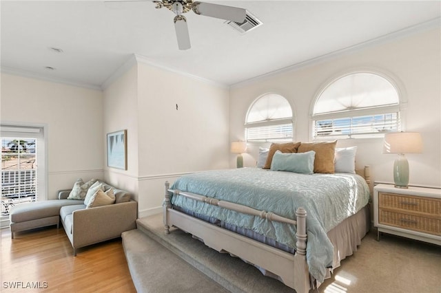 bedroom with light wood-type flooring, ceiling fan, and crown molding