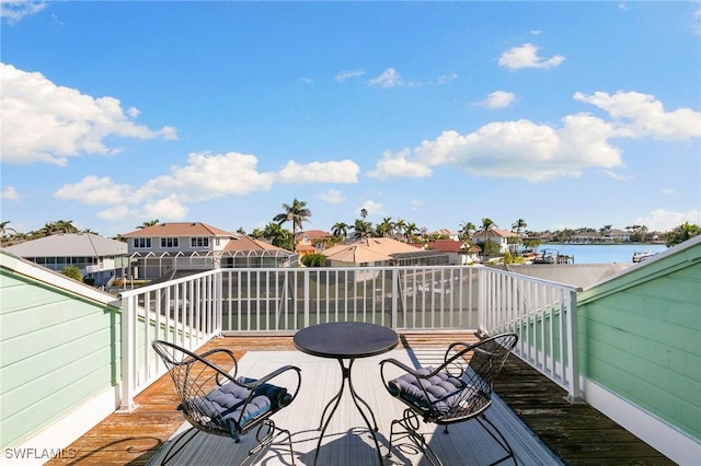 wooden terrace featuring a water view