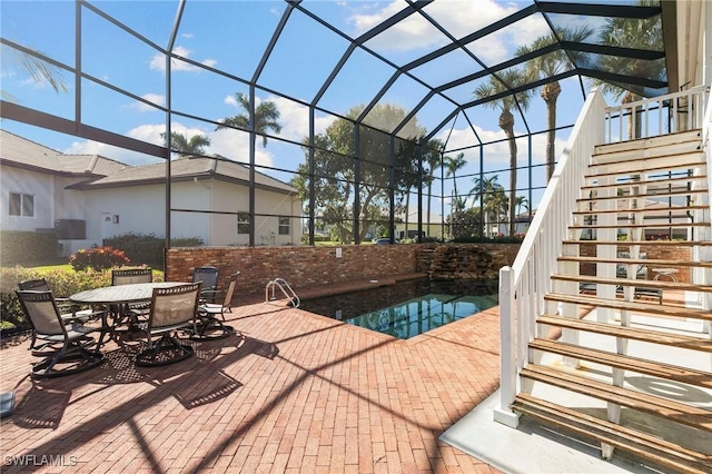 view of pool with a patio and a lanai