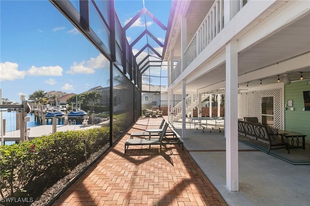 view of patio / terrace with a balcony and a water view