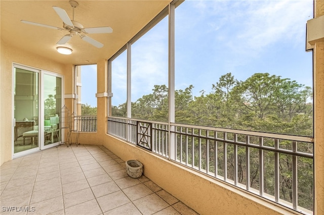 unfurnished sunroom with ceiling fan