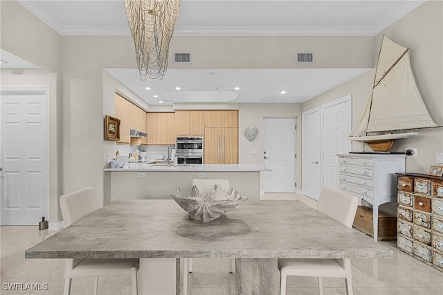 dining area with crown molding and a chandelier