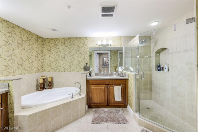 bathroom featuring separate shower and tub, vanity, and tile patterned flooring