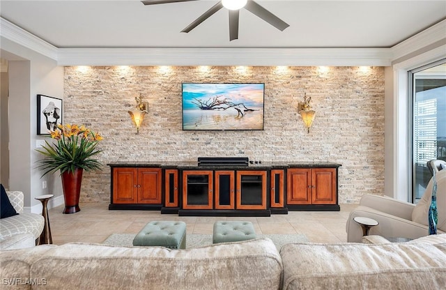 interior space with ceiling fan and ornamental molding