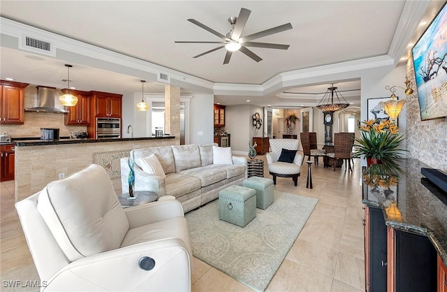 tiled living room with ceiling fan and ornamental molding