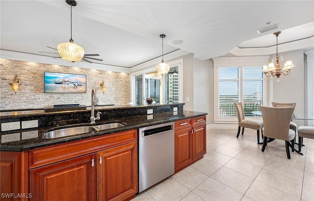 kitchen featuring a sink, dark stone countertops, dishwasher, and hanging light fixtures