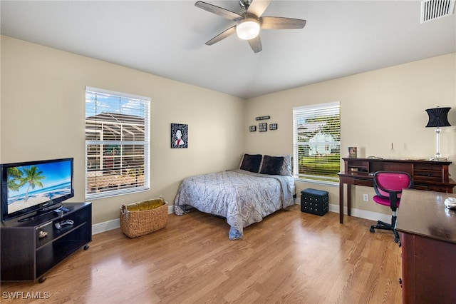 bedroom featuring multiple windows, ceiling fan, and light hardwood / wood-style floors