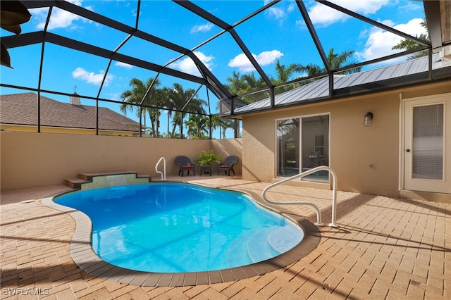 view of swimming pool with a patio area and glass enclosure