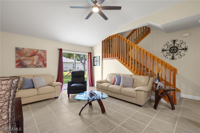 living room featuring ceiling fan, light tile patterned flooring, and lofted ceiling