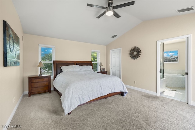 bedroom with ceiling fan, ensuite bathroom, lofted ceiling, and light carpet